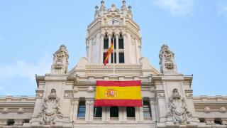 Cybele Palace in the historical center of Madrid, Spain. Madrid city hall with flag of Spain.