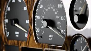 speedometer in car dashboard at full speed