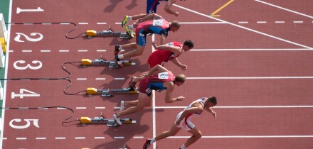 sprinters coming out of their starting blocks one of them too fast. Image shot 2003. Exact date unknown.