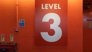 A giant red Level 3 sign in the Oracle public car park, Reading, UK. Concept: level three, number three, third floor, thirdly, car parking level