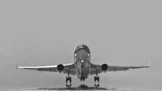 Bonaire Island, Dutch Caribbean, Kralendijk, KLM Douglas DC-10 airplane, taking off from Flamingo Airport. Black and white.