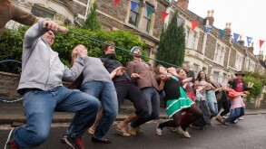 Limbo dance with a hose pipe, during a street party, Bristol.