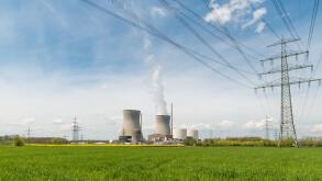 Nuclear power plant with green field and high voltage electric wire in Germany. Europe