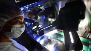 Darmstadt, Germany. 25th June, 2014. The photos released by pharmaceutical and chemical company Merck KGaA shows employee Isabel Ribeiro at the optical final checking station in Merck Pharma Production in Darmstadt, Germany, 25 June 2014. Six special came