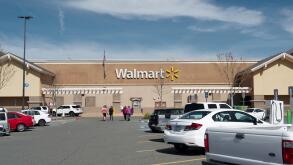 Wallmart store front Dixon, California, USA, on a cloudless sky day, and custommers walking about