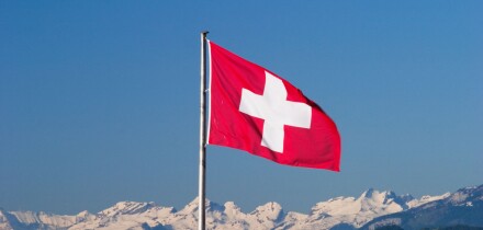 Swiss flag and Alps