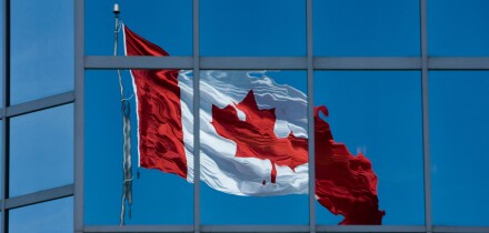 A Canadian flag reflected in the glass of an office building in Halifax, Nova Scotia
