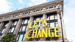 Let's Change the Way We Shop sign outside the Selfiedges store in Oxford Street aiming to improve sustainability business practices.