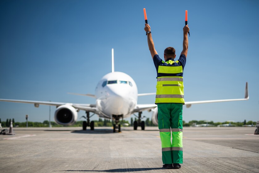 Aviation marshall raising hands and signaling