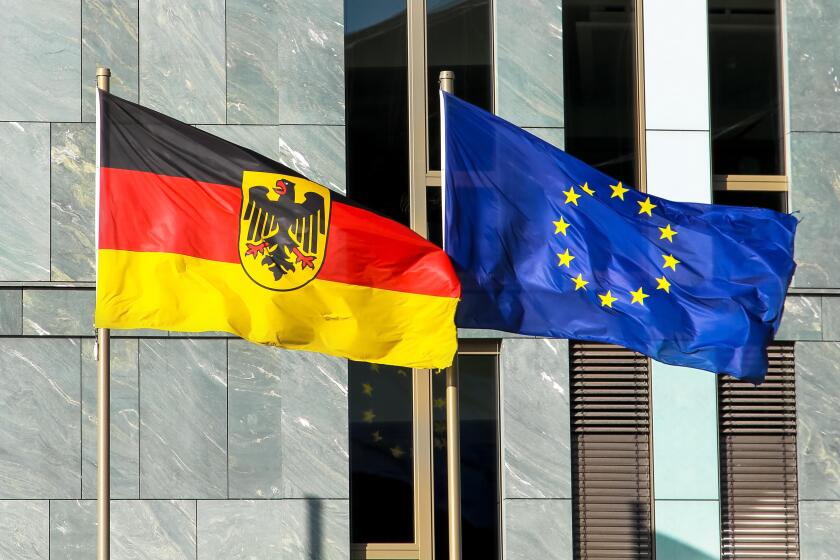 Flags of Germany (Federal Republic of Germany; in German: Bundesrepublik Deutschland) and the European Union (EU) waving in the wind.