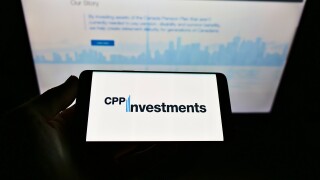 STUTTGART, GERMANY - Mar 14, 2021: Person holding mobile phone with logo of Canada Pension Plan Investment Board on screen with webpage