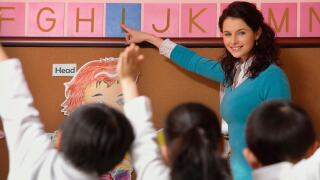 Teacher teaching alphabet in class