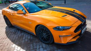 A 2018 registered orange and black Ford Mustang 5.0 sports  car in North Yorkshire England UK