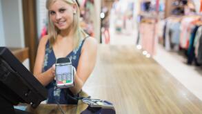 Woman holding credit card machine. Image shot 01/2013. Exact date unknown.