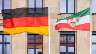 Flags of the federal state of North Rhine Westphalia and the German flag outside a government building, Dusseldorf, NRW, Germany
