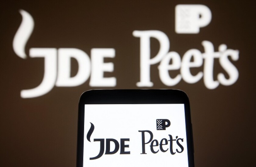 In this photo illustration a JDE Peet's logo is seen on a smartphone and a pc screen. (Photo by Pavlo Gonchar / SOPA Images/Sipa USA)
