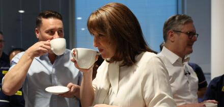 Britain's Chancellor of the Exchequer Rachel Reeves, center, Britain's Health Secretary Wes Streeting, left, and Britain's Prime Minister Keir Starmer hold hot drinks as they talk with Nurses during a visit to University College London Hospital in London,
