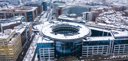 Brussels, Belgium - 8 February 2021: Aerial view of a European Union building under the snow at wintertime near Parque du Cinquantenaire.