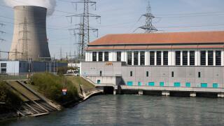 A general view shows the hydropower station Wasserkraftwerk Goesgen of Swiss energy company Alpiq, in front of the cooling tower of the nuclear power plant KKW Goesgen of Swiss energy company Kernkraftwerk Goesgen-Daeniken AG, in Niedergoesgen, Switzerlan