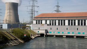 A general view shows the hydropower station Wasserkraftwerk Goesgen of Swiss energy company Alpiq, in front of the cooling tower of the nuclear power plant KKW Goesgen of Swiss energy company Kernkraftwerk Goesgen-Daeniken AG, in Niedergoesgen, Switzerlan