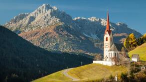 Autumn morning at the iconic church of Sankt Nikolaus in Winnebach, South Tyrol, Italy. Dolomites.