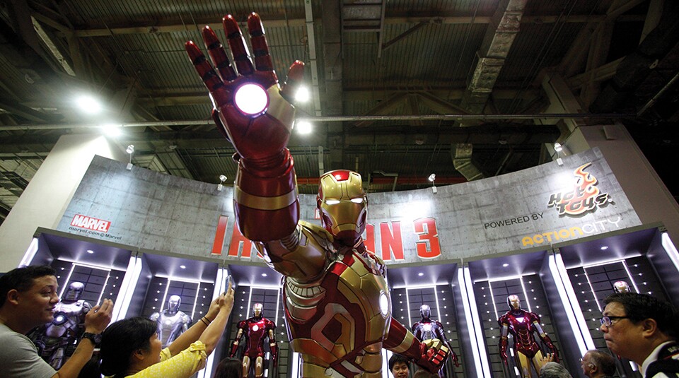 Visitors take photos of an Ironman exhibit at the Singapore Toy, Game and Comic Convention