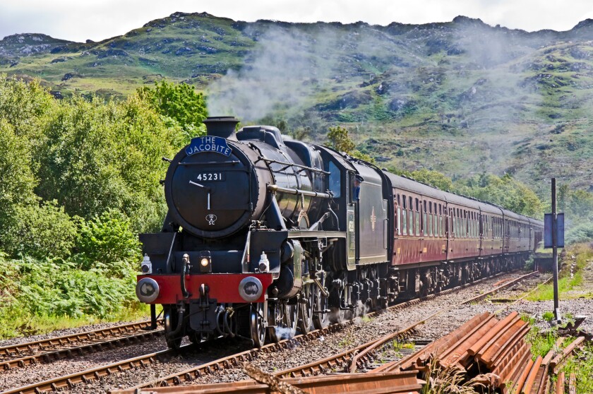 The Jacobite steam train approaches Arisaig railway station at Arisaig in the West Highlands of Scotland