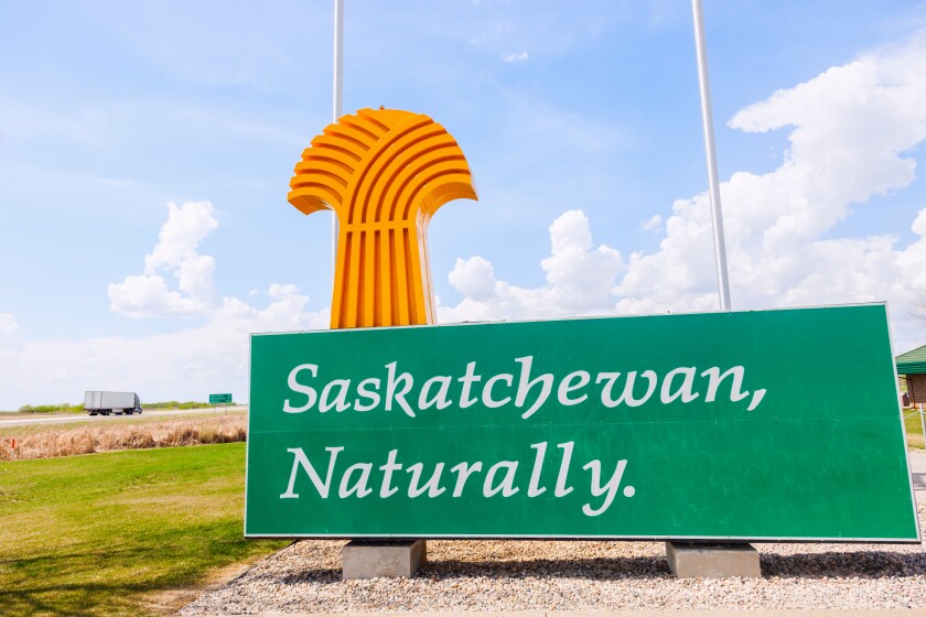 Welcome to Saskatchewan - sign and flags