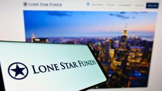 Cellphone with logo of US investment company Lone Star Funds on screen in front of business website. Focus on center-right of phone display.