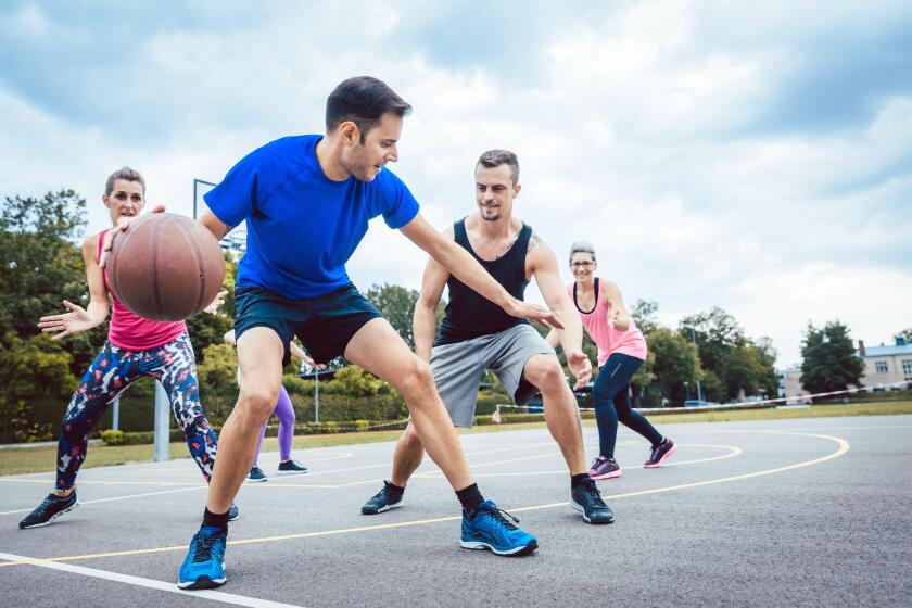 Group of friends are playing basketball outdoors