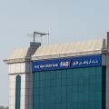 "Ras al Khaimah, Ras al Khaimah/United Arab Emirates - 7/4/2019: "First Abu Dhabi (FAB) Bank blue storefront on a blue sky sunny day. "