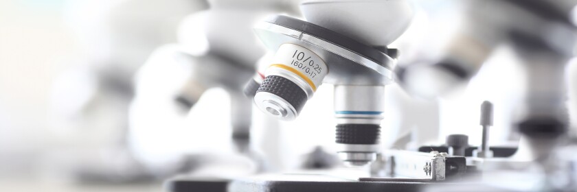 Set of microscopes standing in row in school chemist classroom