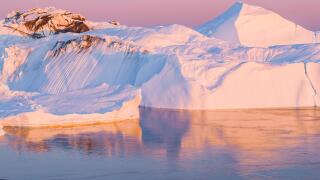 Climate Change and Global Warming - Icebergs from melting glacier in icefjord in Ilulissat, Greenland. Aerial image of arctic nature ice landscape. Unesco World Heritage Site.