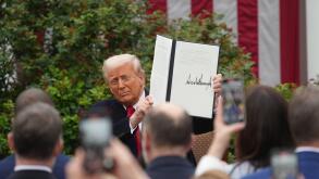 Washington, United States Of America. 02nd Apr, 2025. United States President Donald J Trump displays the signed Executive Order after concluding his remarks during a ?Make America Wealthy Again? event in the Rose Garden of the White House in Washington, 
