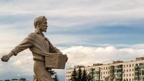 Stone man walking forward casting seeds towards the sky