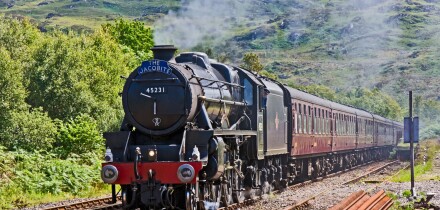 The Jacobite steam train approaches Arisaig railway station at Arisaig in the West Highlands of Scotland
