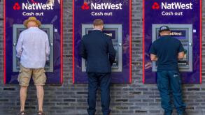 Men at the cash dispenser of NatWest Bank, London, Great Britain