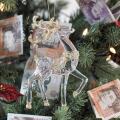 Christmas Tree with ten pound and twenty pound notes as decoration with a glass and gold reindeer in the foreground, expensive Christmas