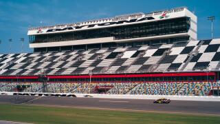 Daytona Beach, Florida, USA - July 20 2012: Daytona International Speedway with Nascar Racecar passing by on the Circuit.