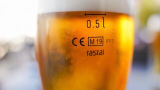 Cisal glass of full beer with CE Marking 0.5l  on table in Spain..