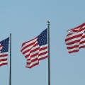 Stars and Stripes flags flying on three flagpoles United States of America USA