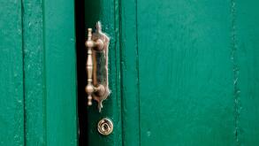 old door ajar with ornate handle