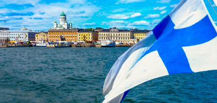 Helsinki skyline from the sea.The Finnish flag is floating. Market Square and Helsinki Cathedral from the sea. The seascape of Helsinki in the summer.