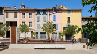 Colourful French houses beside the Cathedral Saint - Michel in Carcassonne, France.