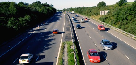 Traffic in the early morning light on the M4 in South Wales UK GB