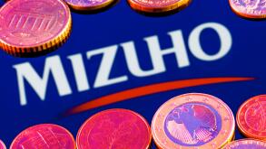Variety of metal coins on background of Mizuho Financial Group logo