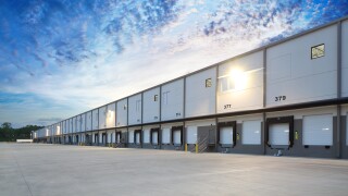 Exterior of modern distribution center warehouse at sunrise