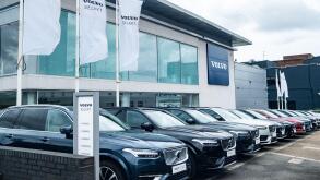LONDON- JULY 31, 2023: Volvo car dealership-cars parked outside showroom with Volvo logo above. Swedish vehicle manufacturer.