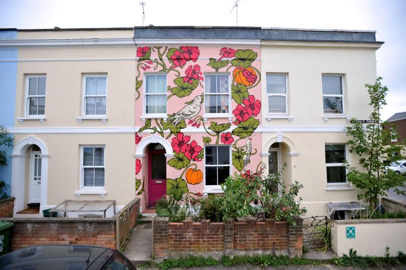 Artist Alex Lucas from Bristol with the house she painted in Cheltenham that coincided with the Cheltenham Paint Festival celebrating street art