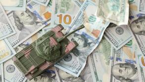 Tank on crumpled hundred dollar bills banknotes. Background of war funding and military support price for United States of America. Tank on crumpled